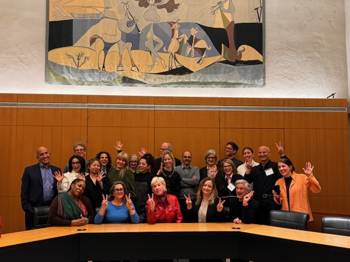 People posing happily for a group picture.